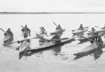early kayakers show off the design of their kayak paddle