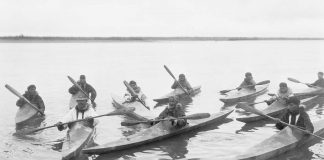 early kayakers show off the design of their kayak paddle