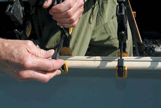 Carefully marking the centre point on everything makes assembly fast and accurate. To “cut your boat down” simply clamp the gunwales lower and then trim the Royalex later. Be careful—the two pieces of wood must be constantly checked for matching heights. | Photo: Scott MacGregor
