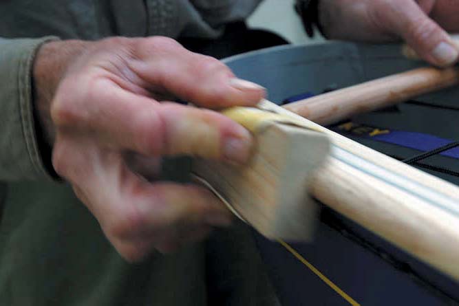 a homemade sanding block smooths wood canoe gunwales