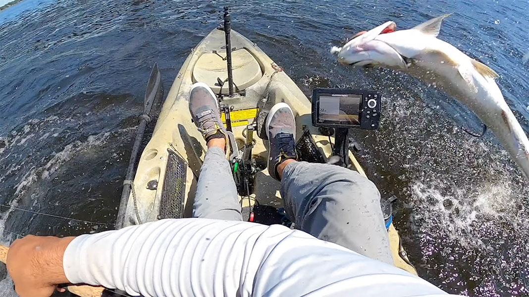 tarpon jumps at kayak and breaks fishing rod