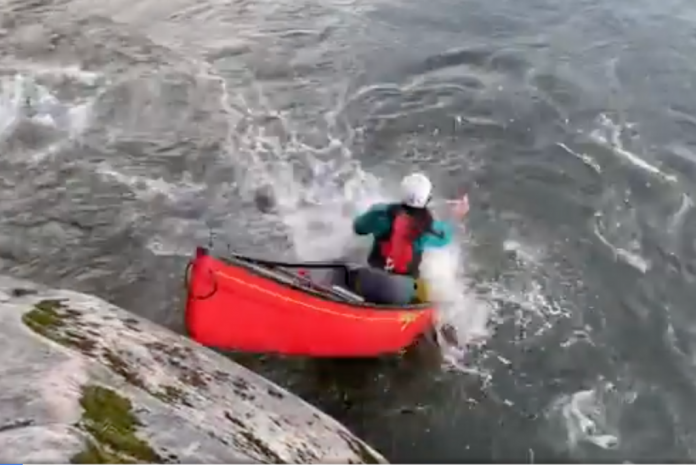 man attempting to seal launch his canoe, but hitting the water with his face