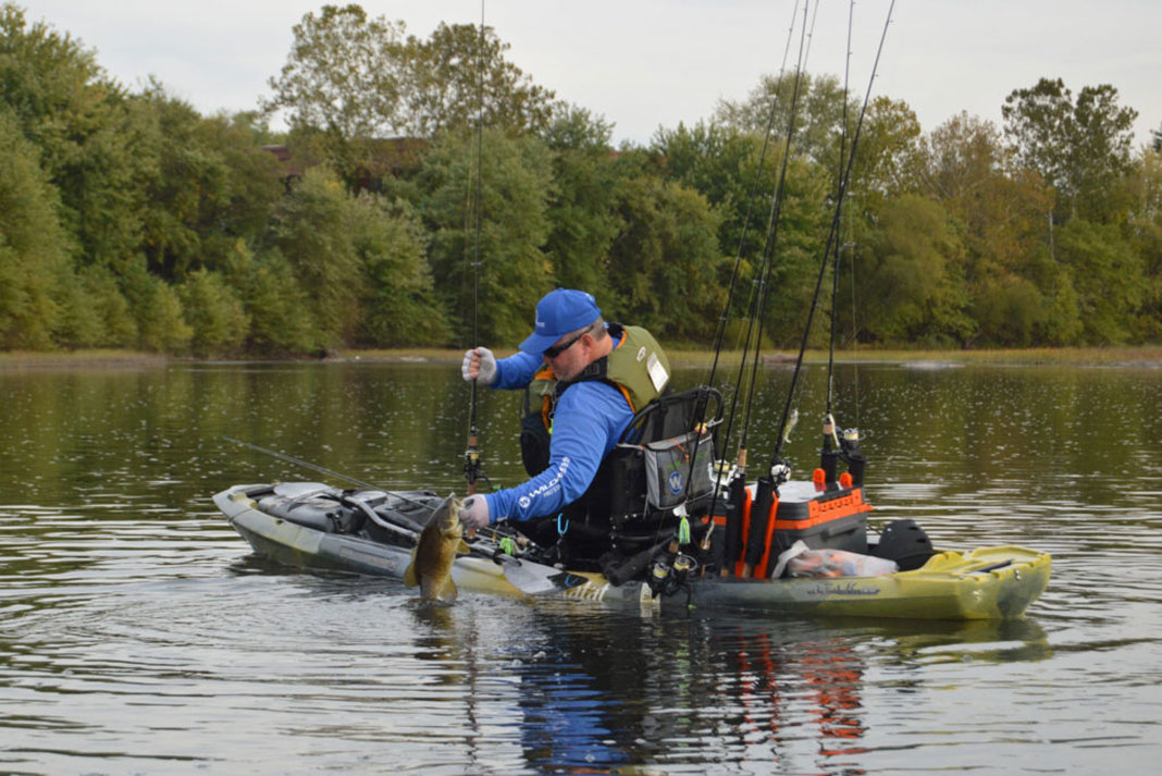 kayak angler fishing for bass in the fall