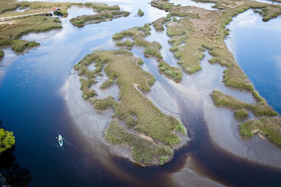 kayak anglers ride the outgoing tide in South Carolina in search of redfish