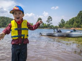 a kid gasps in excitement on his first kayak fishing trip