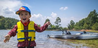 a kid gasps in excitement on his first kayak fishing trip