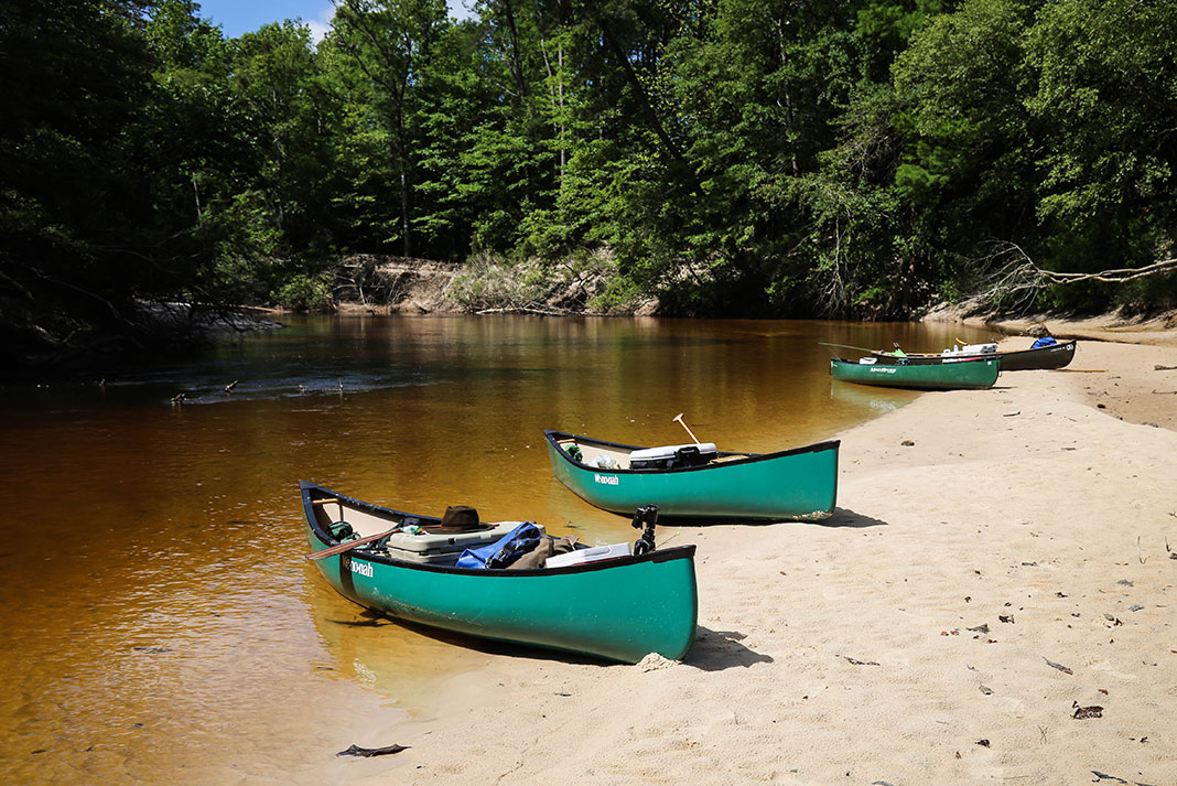 canoes on the shore of a river in Alabama
