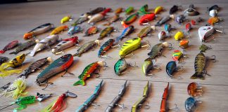 a selection of fishing lures laid out on a surface