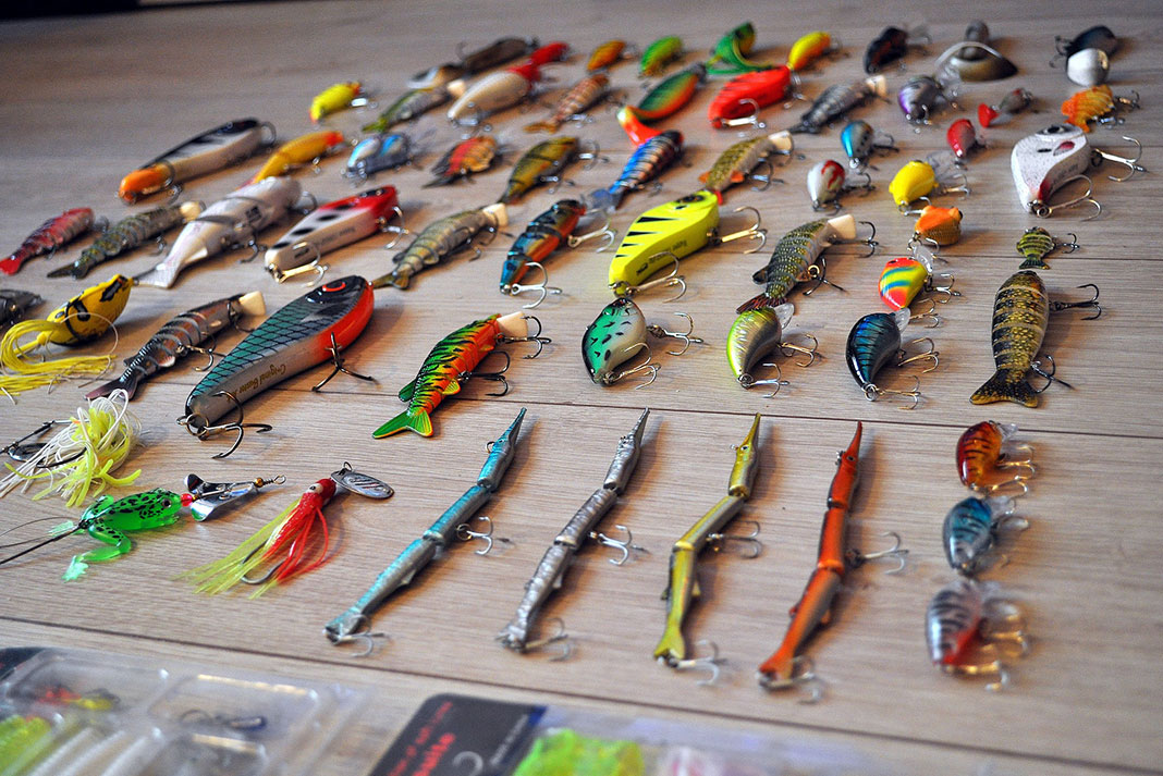 a selection of fishing lures laid out on a surface