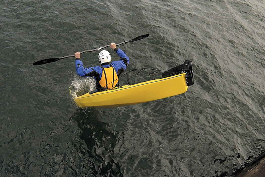 man in a sea kayak demonstrates the seal launch