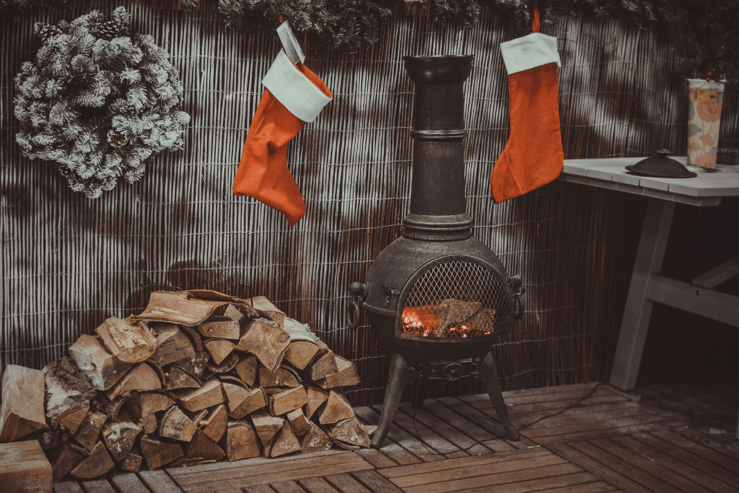 holiday stockings hung up in front of a fireplace