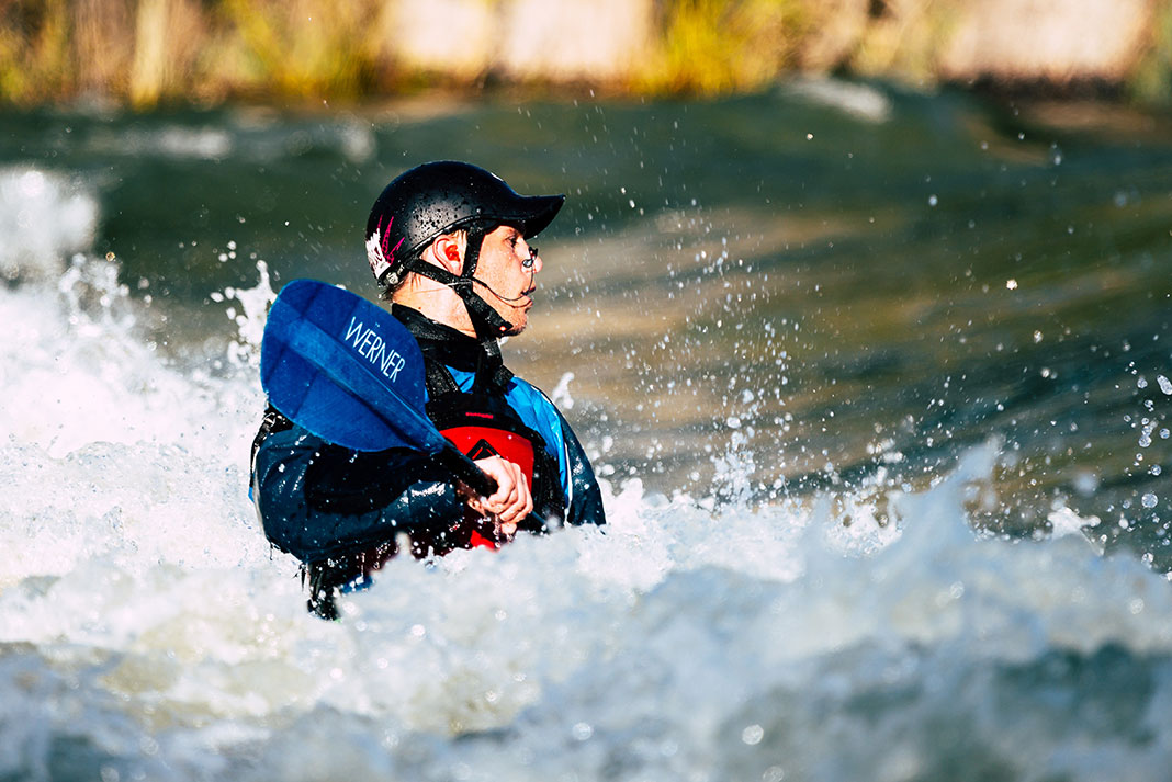 male freestyle kayaker in whitewater