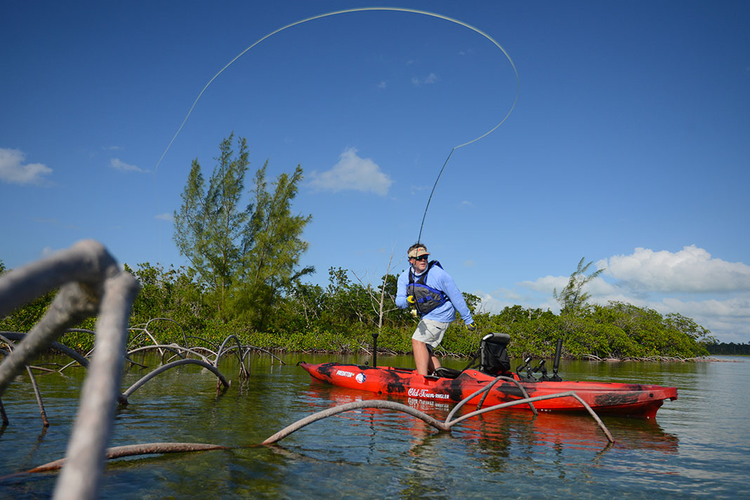 man fly fishing from a kayak