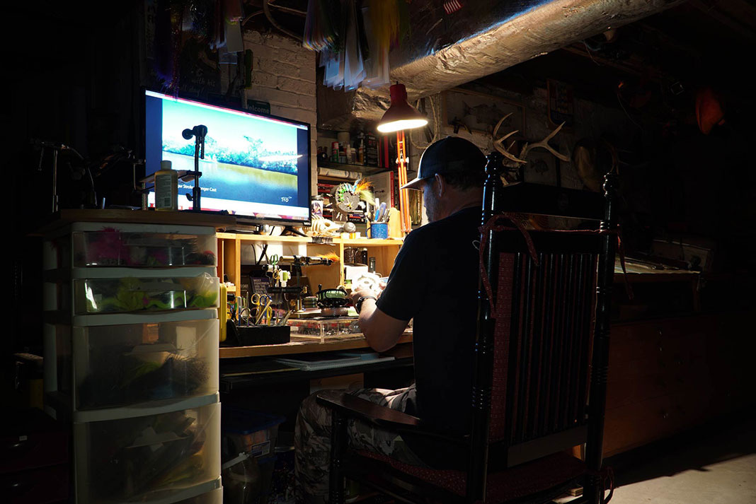 man works at home on passion projects during the fishing off season