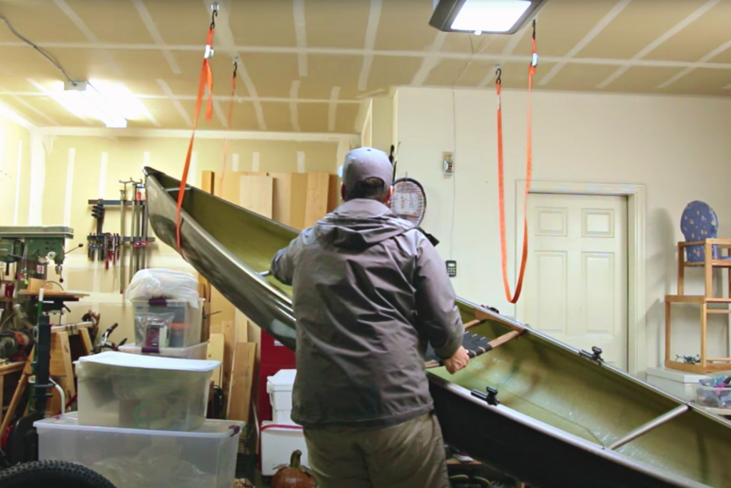 man stores canoe in garage