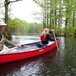 Everything You Need To Know About Old Town Canoes Two canoes being paddled along river