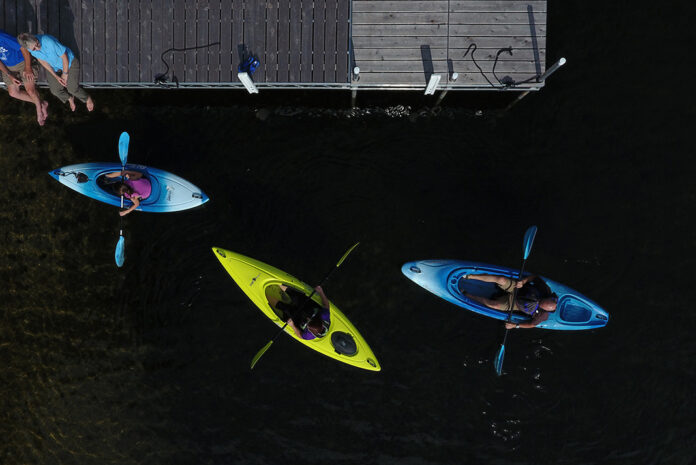 Overhead shot of people in three kayaks