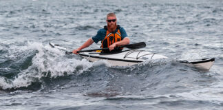 Man paddling white touring kayak t