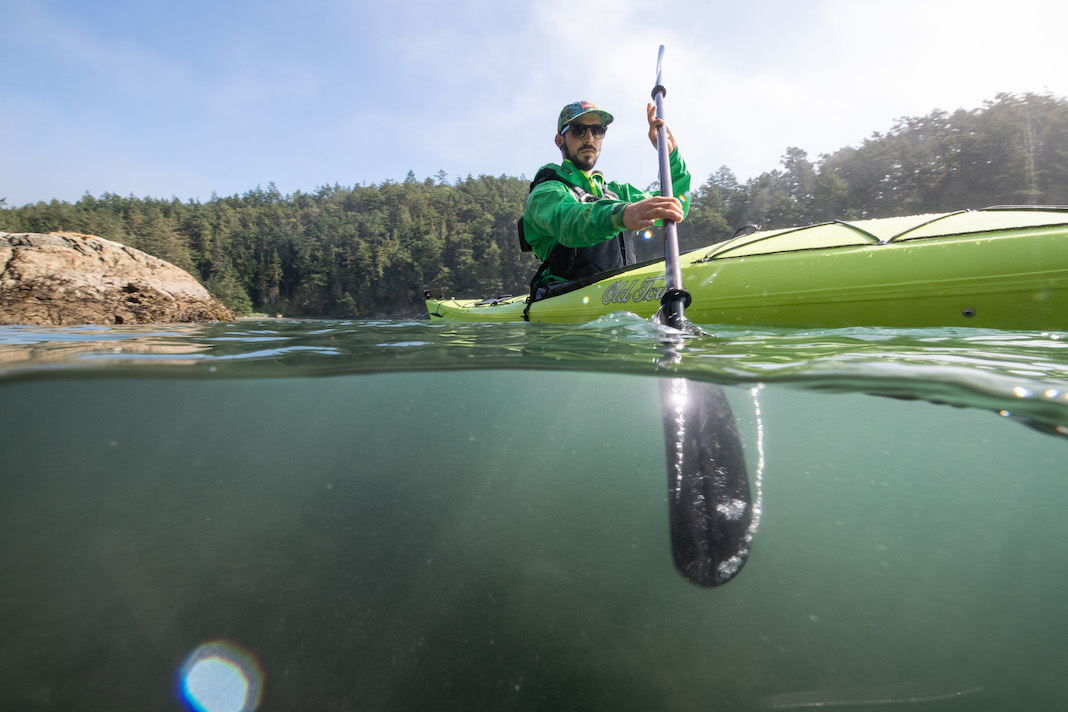 Man paddling lime green day touring kayak