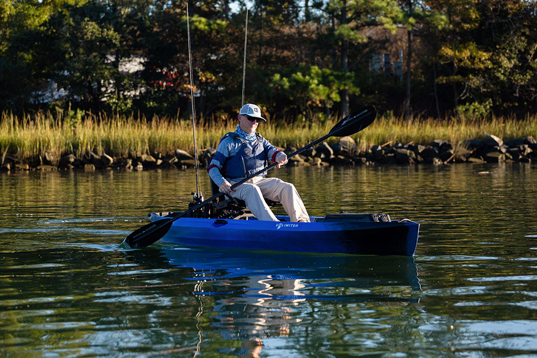 Man paddling blue sit-on-top kayak
