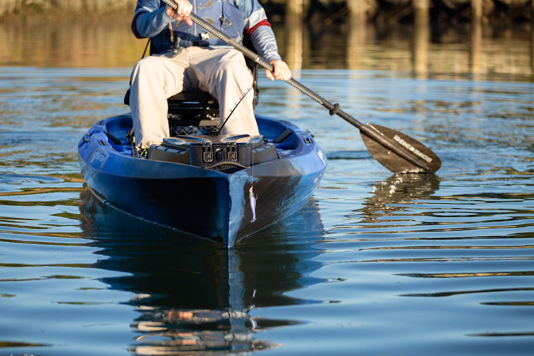 Man sitting on stadium seat on sit-on-top kayak paddling