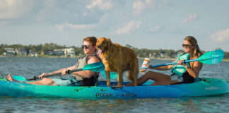 Man, woman and dog on sit-on-top tandem kayak