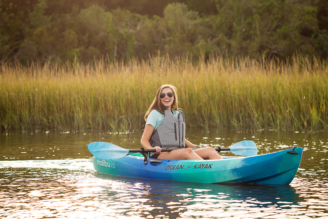 Woman paddling sit-on-top kayak