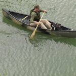 Solo Canoe Review: Old Town Discovery 119 Man paddling solo canoe