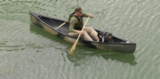 Man paddling solo canoe