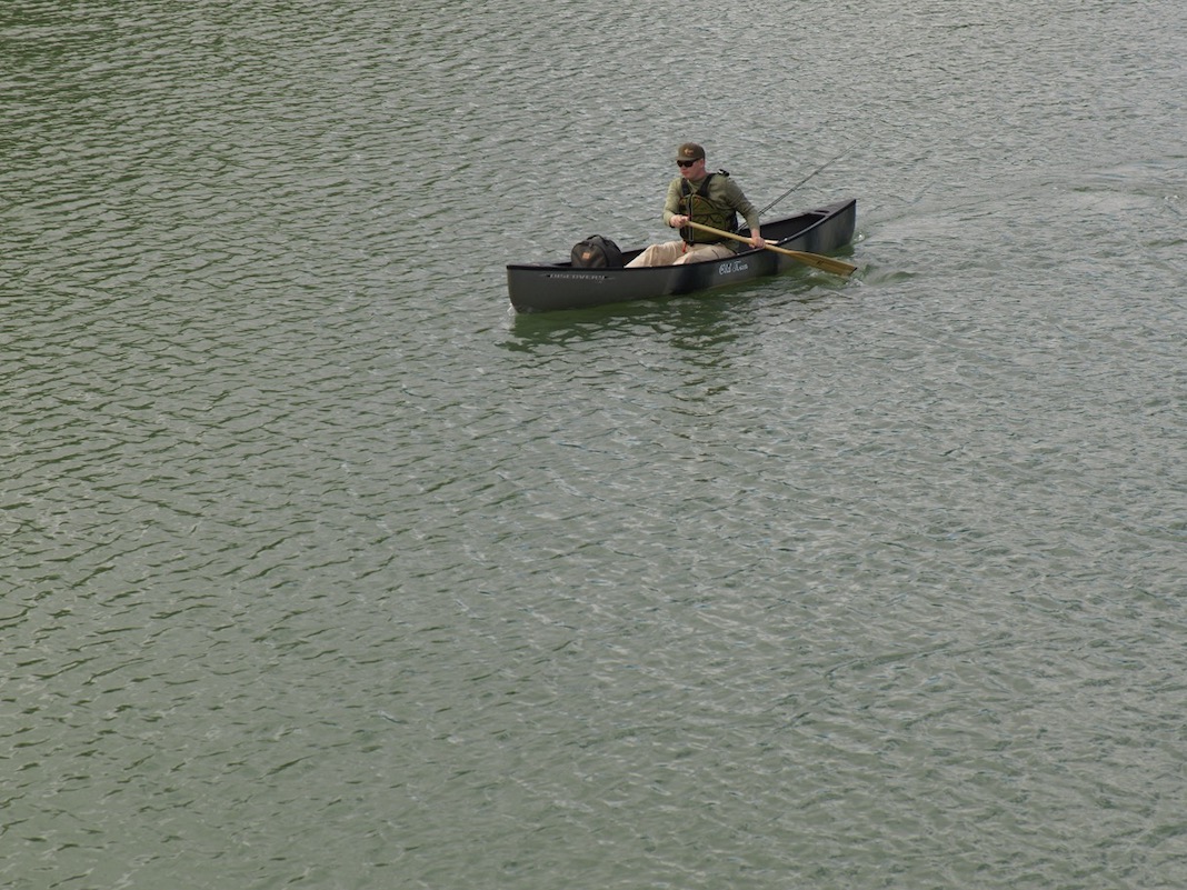 Man paddles solo canoe