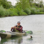 Fishing Kayak Review: Old Town Vapor 10 Man fishing from sit-inside kayak