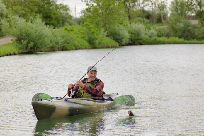 Man fishing from sit-inside kayak