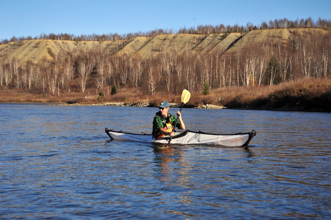 Man paddling folding kayak on a lake