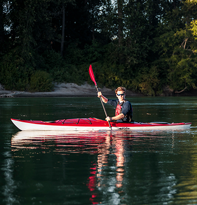 Man paddling red and white rec kayak