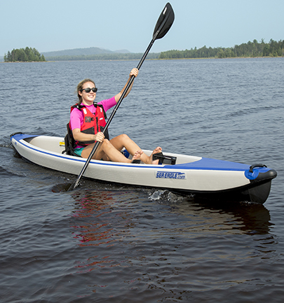 Woman paddling inflatable kayak