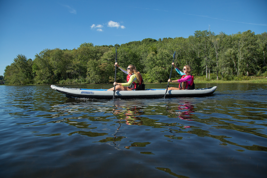 Two people paddling tandem inflatable kayak