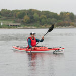 Touring Kayak Review: Stellar S14 G2 Man paddling red and white touring kayak