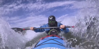 a kayaker demonstrates how to lean forward and kayak through waves
