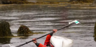 man demonstrates a C to C sea kayak roll