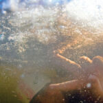 3 Pros On How To Perfect Your Kayak Roll underwater picture of a kayaker executing a kayak roll