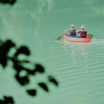 5 Ways Canoeing Can Help You Live Longer two older canoeists seek out Blue Zones by paddling through turquoise waters