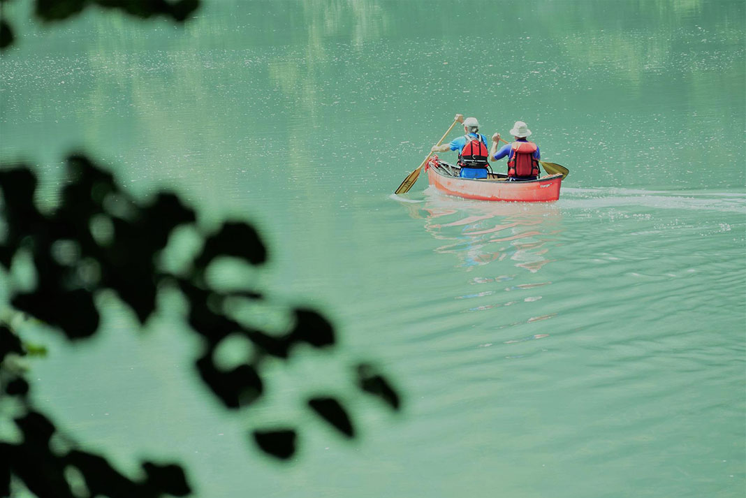 two older canoeists seek out Blue Zones by paddling through turquoise waters