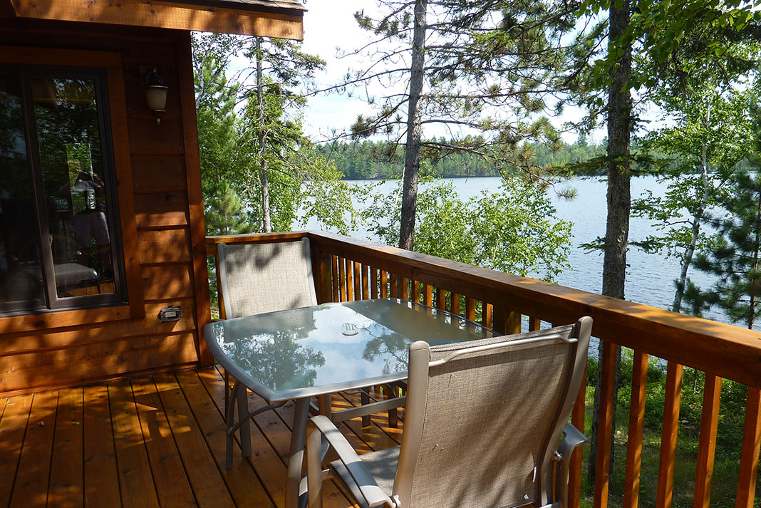 deck and seating area look over the water at a cabin at River Point Resort 