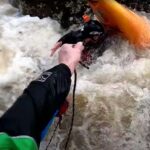 Dramatic Footage Shows Kayaker Saved By Quick Acting Friends (Video) kayaker is thrown a rope while stuck in a river pin