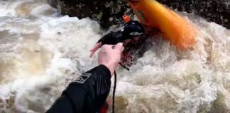 kayaker is thrown a rope while stuck in a river pin