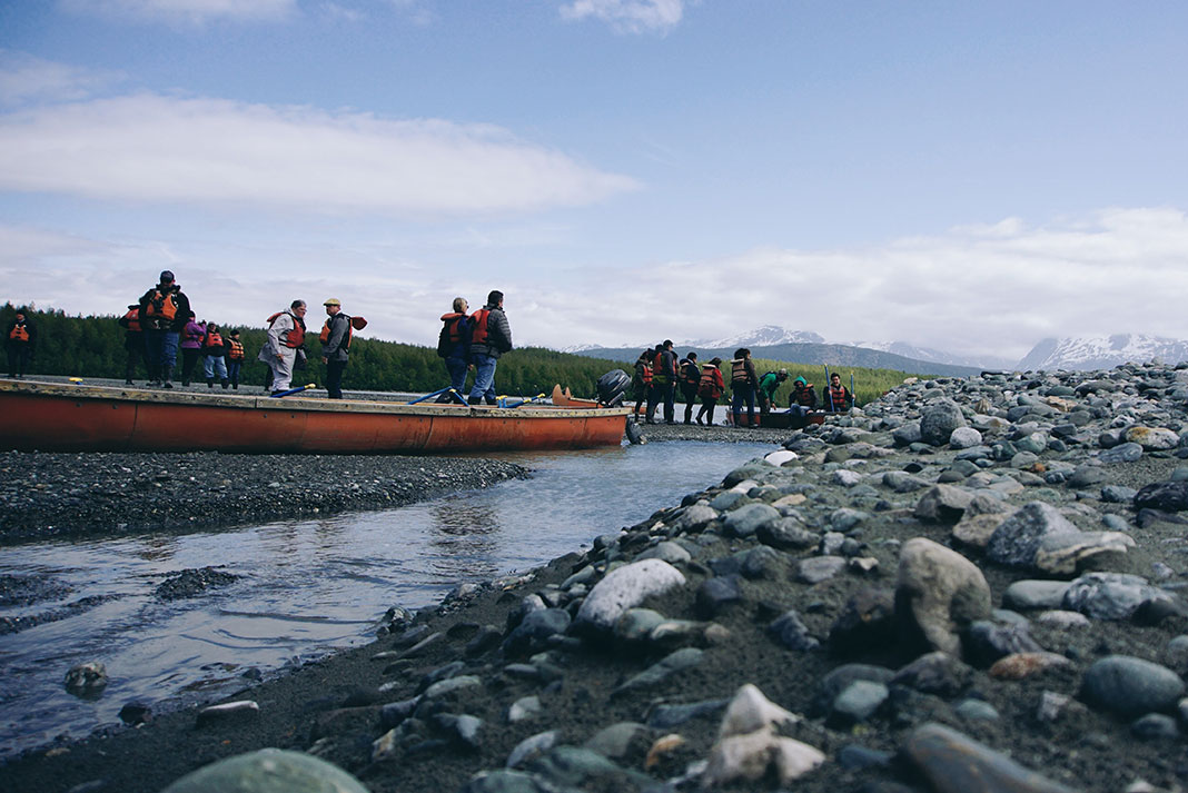 a group of people prepare for a canoe trip in Alaska