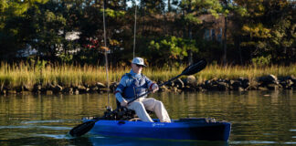 Man paddling blue sit-on-top kayak
