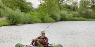 Man fishing from sit-inside kayak