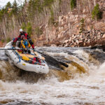 Dream Trip: How To Turn Your Paddling Fantasies Into Reality a group of whitewater rafters go over some rapids on a paddling dream trip