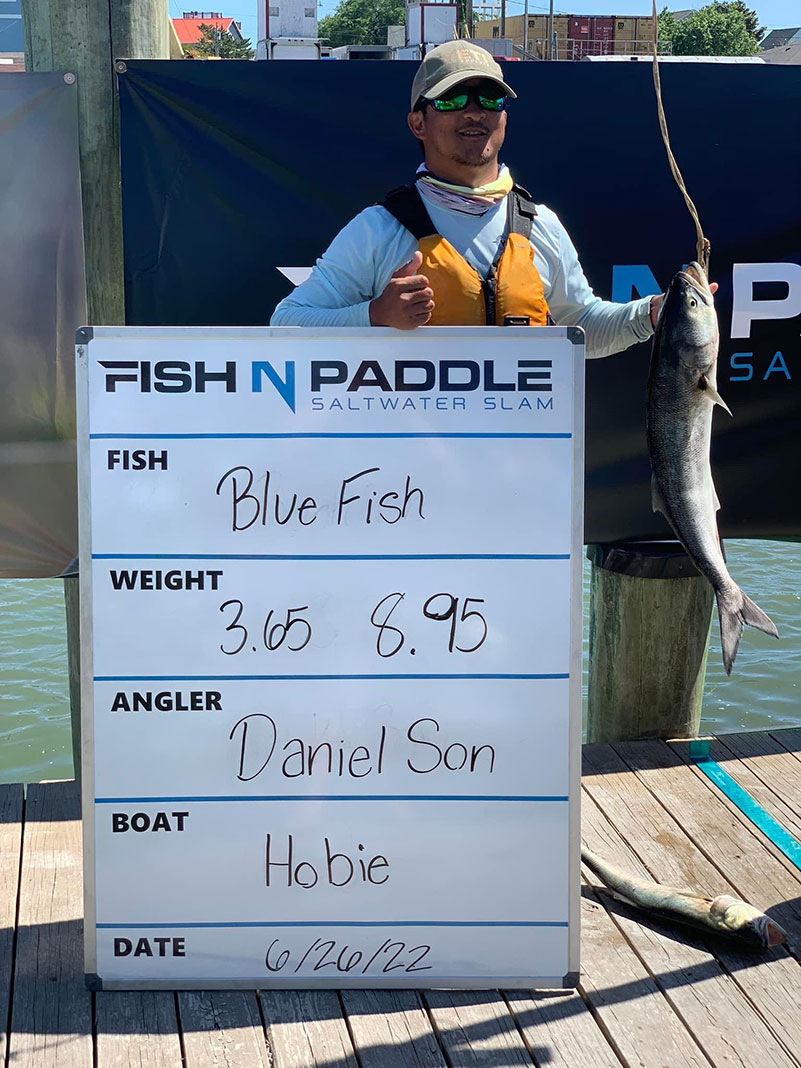 third place finisher of the Fish N Paddle Saltwater Slam poses with his catch
